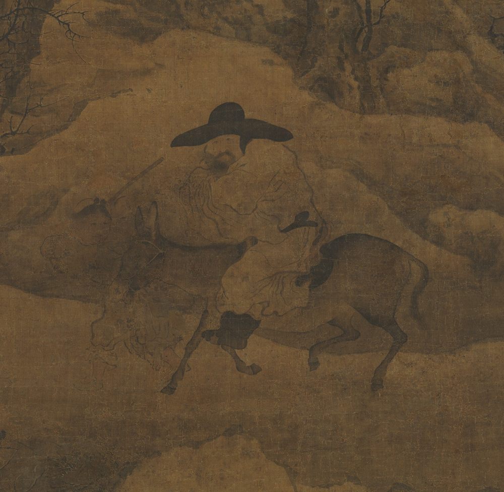 Detail of an ink landscape on warm brown silk: a traveller in a wide black hat rides a donkey along a snow-covered slope, a second figure following on foot, with bare gnarled trees above them and drifted snow all around.